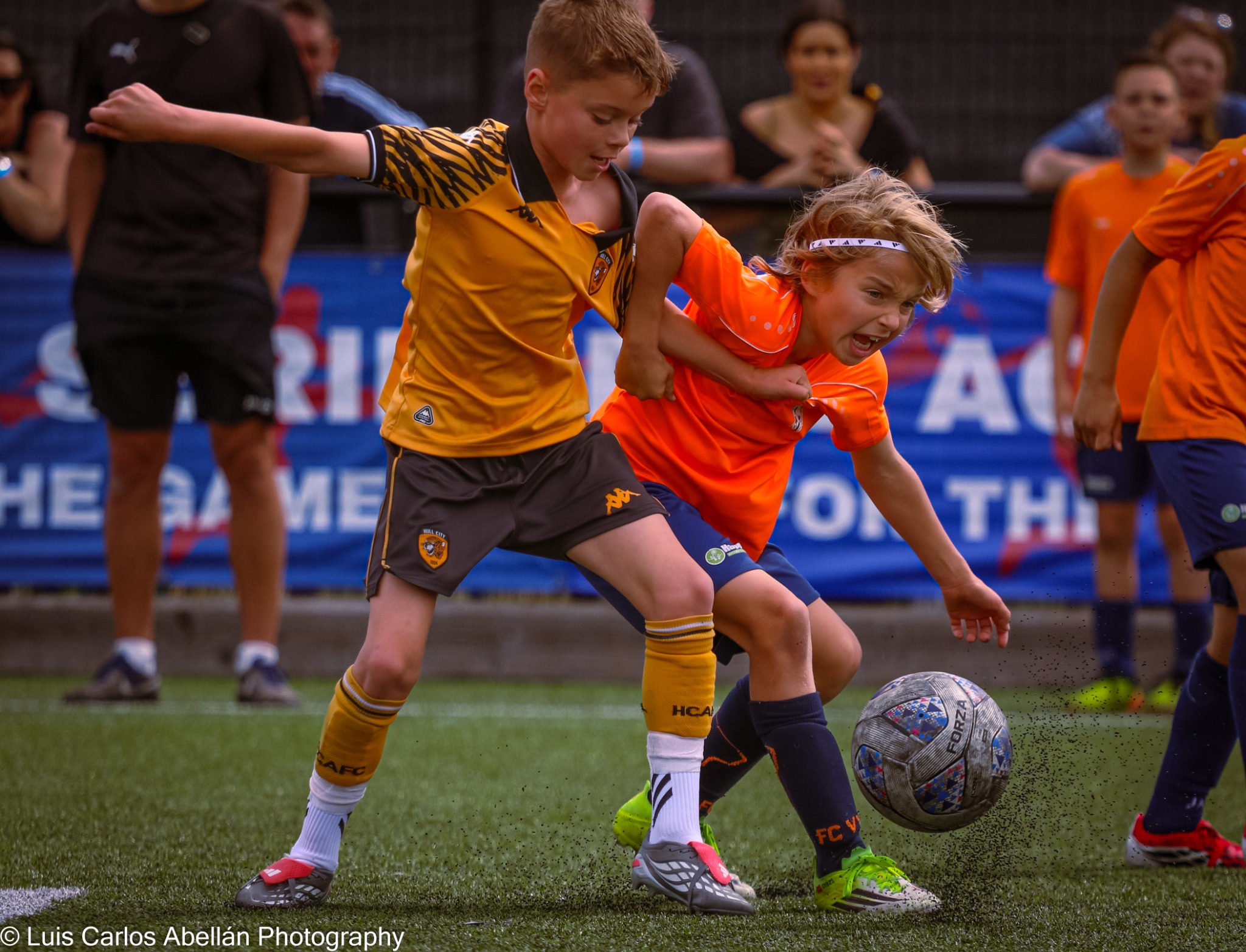 Young footballers competing for the ball