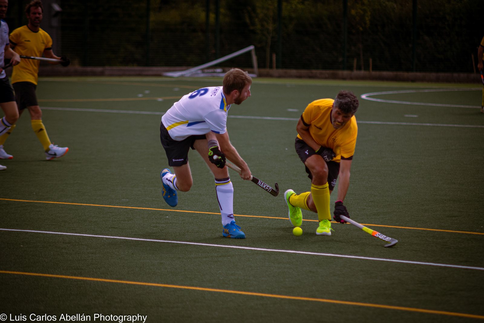 Two hockey players contesting possession with their sticks
